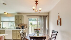 A dining area with a wooden table, four chairs, and a chandelier. There is a window with blinds and a view of the outside. - 5 Mi to Downtown Harrisburg - Family Home! (Harrisburg)