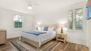 A bedroom with a bed, bedside lamps, a ceiling fan, and a window with blinds. - Pinewood Views: 2BR | 2BA, Sleeps 6 + Free Attraction Tickets! (Santa Rosa Beach)