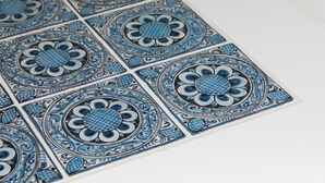 A close-up of a patterned tile with a blue and white design.