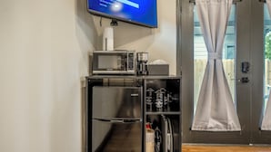 A compact kitchenette with a microwave, coffee maker, and refrigerator. - HTX Ultra Hotel Suite #2 (Houston)