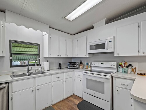 This popular 3 BR/2 BA home sits on a canal in the gated community of Paradise Village