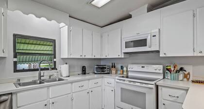 This popular 3 BR/2 BA home sits on a canal in the gated community of Paradise Village