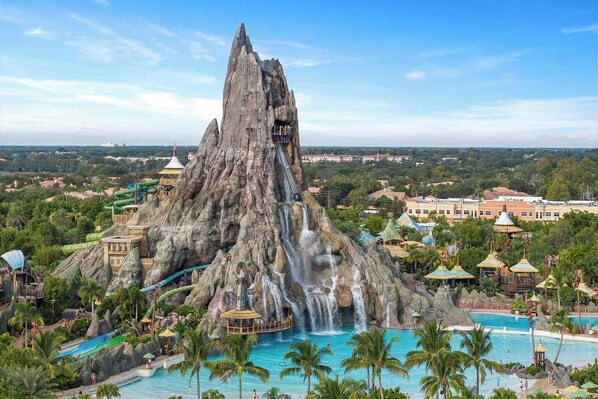 Surrounded by lush palm trees and a serene pool, this mountain offers breathtaking views of a cascading waterfall.