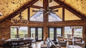 A spacious wooden interior with a high ceiling, large windows, and a dining area. - Lookout Lodge- Blue Ridge GA (Blue Ridge)