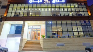 A multi-story hotel with illuminated signage and a modern design. - Hotel El Bey Jijel  (Jijel)