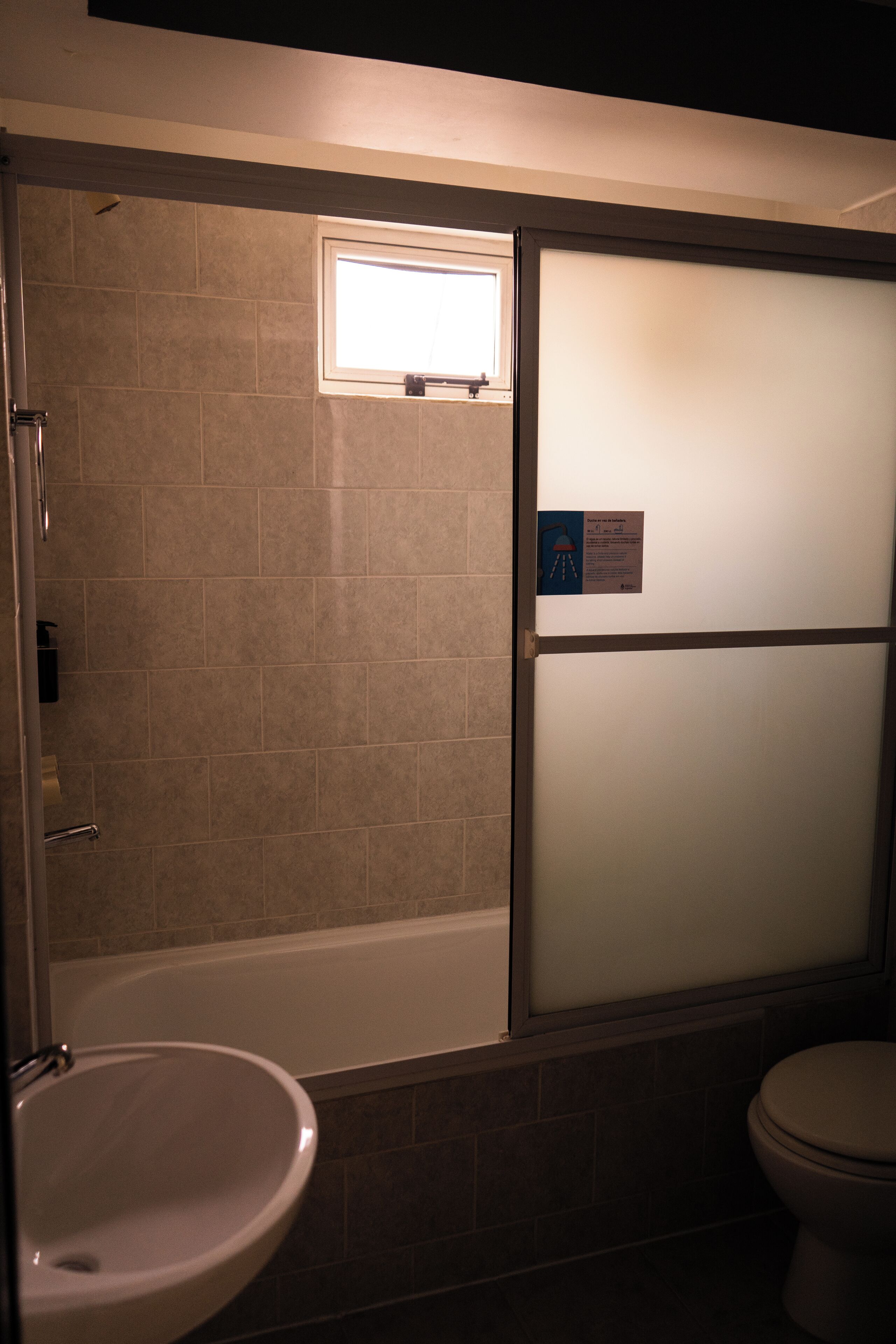 A bathroom with a bathtub, a sink, and a toilet.