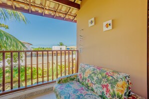 Enjoy the neighborhood view from this balcony with a seating area and framed artwork.