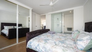 A bedroom with a large bed, a separate sofa, a walk-in closet, and a shower area. - Escape to Tranquility at Fountain View Villa - South Yunderup (South Yunderup)