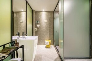 A modern bathroom with a large white sink, a yellow trash bin, and a glass shower enclosure. - Shenzhen Zhongtian Meijing Hotel (Bao'an International Airport Xixiang Subway Station) (Shenzhen)