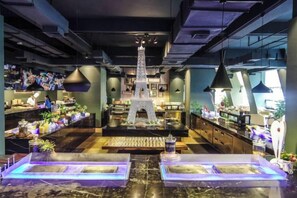 A bar area with a central Eiffel Tower model, seating, and bar counters. - Beihai Hyatt Hotel (high-speed railway station store) (Beihai)