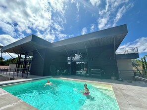 Relax by the rectangular pool surrounded by lounge chairs and take in the views from the balcony with a flat roof.