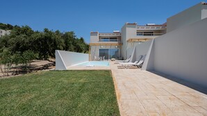A modern building with a swimming pool, outdoor seating, and a clear sky. - Mythos villa 7,pool,Walking distance to beach (Damnoni)