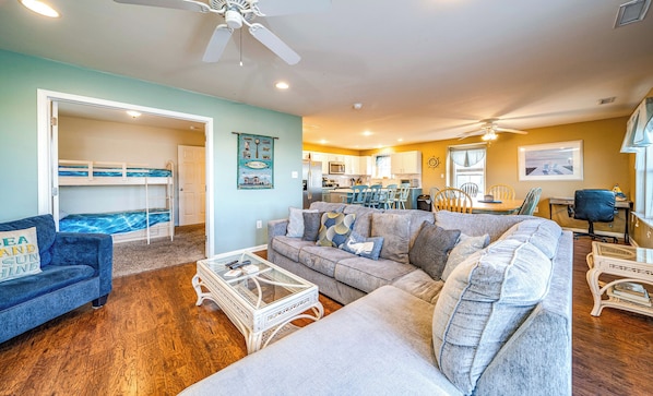 Relax in this inviting space with a sofa, couch, and dining area, perfect for meals and socializing.