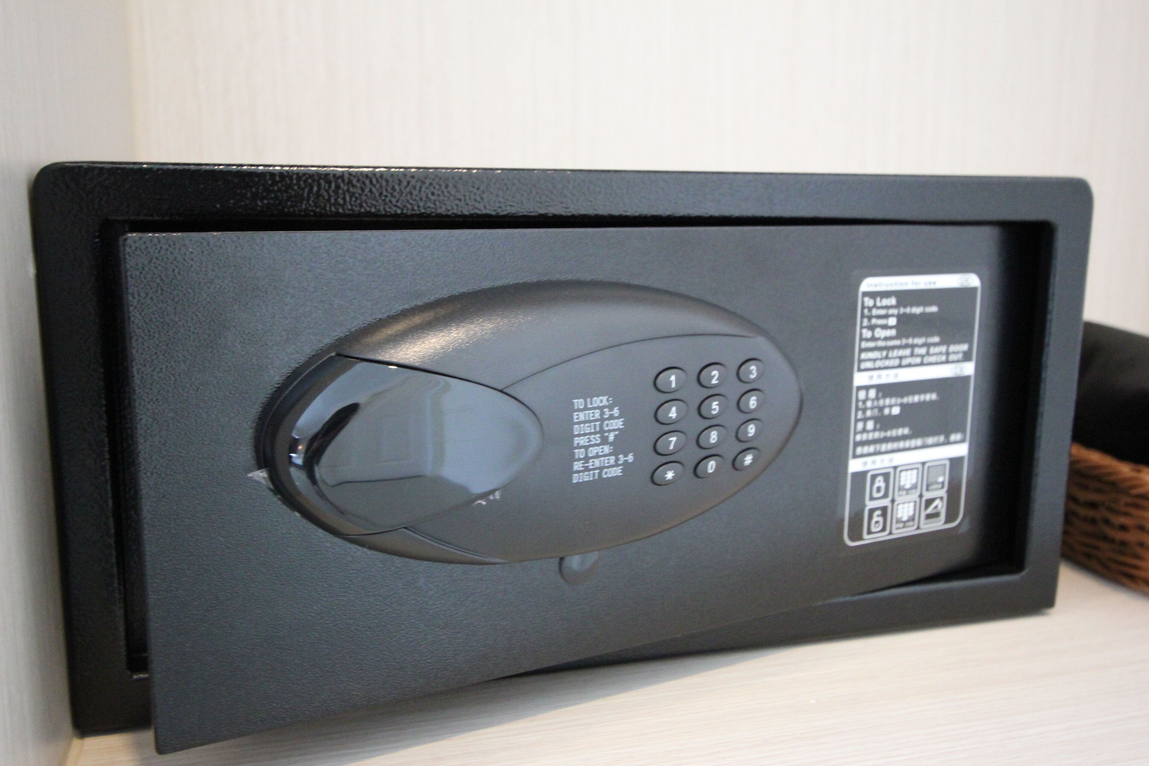 A black electronic keypad lock on a door.