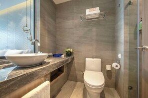 A modern bathroom with a large vessel sink, a toilet, a glass shower enclosure, and a marble countertop. - Orange Hotel (Suzhou Dushu Lake Xi'an Jiaotong-Liverpool University) (Suzhou)