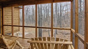 A wooden cabin with large windows overlooking a forest. - Beautiful Mountain Home, Ski In/Ski Out & Golf within Boyne Mountain Resort (Boyne falls)