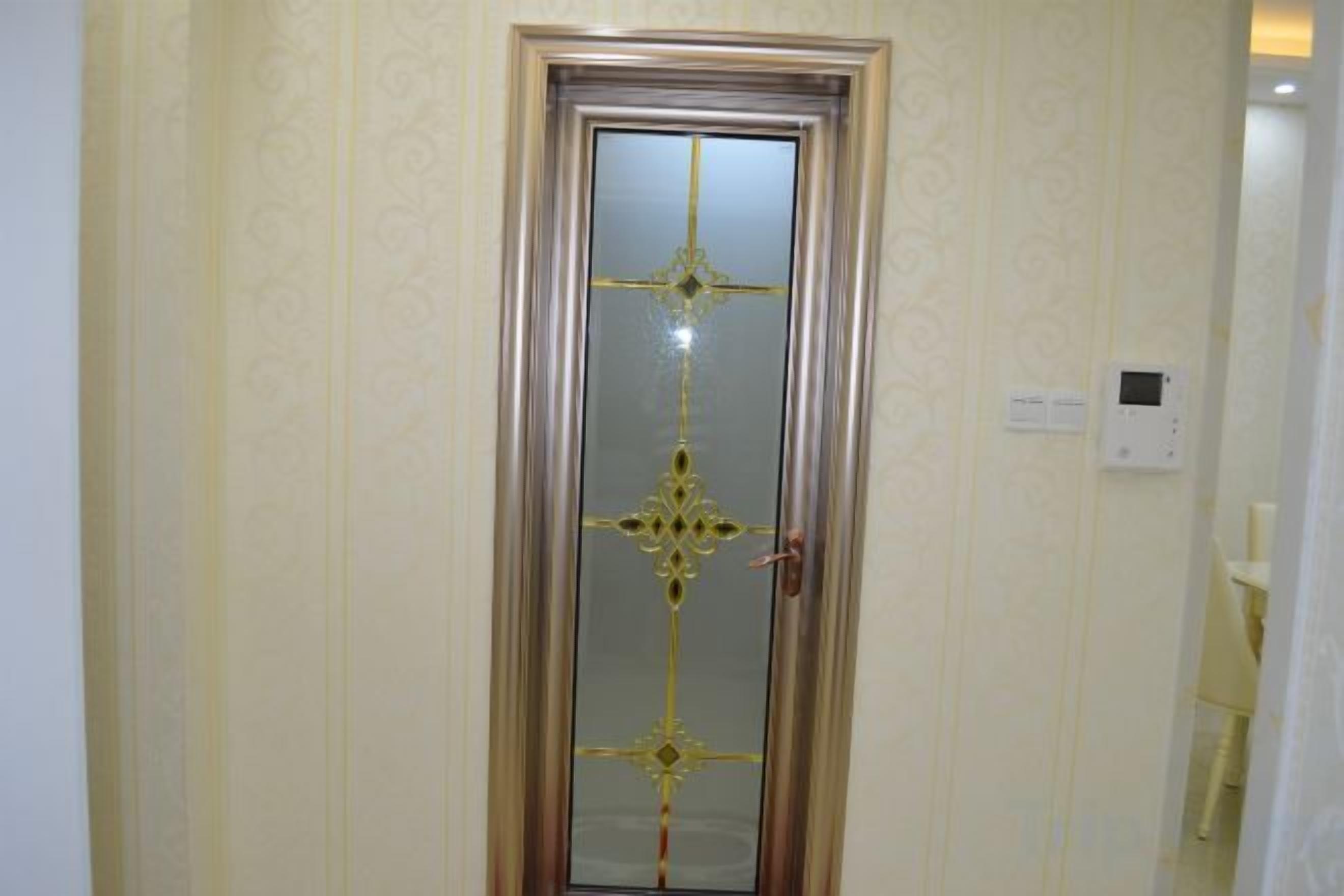 A door with a decorative glass panel and a handle.