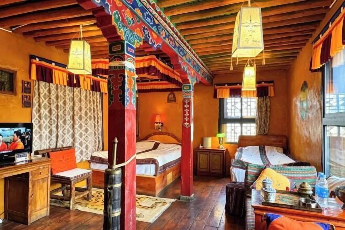 A traditional room with a bed, desk, and television.