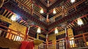 A traditional building with wooden beams and a high ceiling. - Shambhala Palace Hotel (Lhasa)