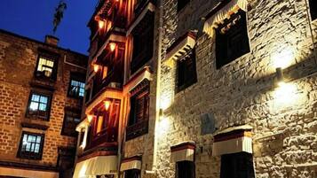 A multi-story building with stone walls and wooden balconies.