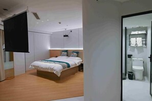A modern bedroom with a bed, bedside tables, a wardrobe, and a bathroom visible through an open door. - Sihe Haichuan Hostel (Nanping)