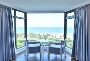 Enjoy a panoramic ocean view from the bay window, with a comfortable seating area for two.