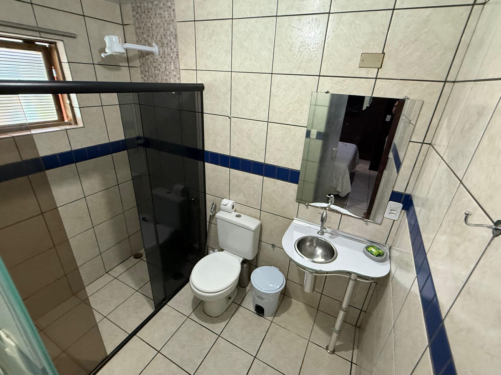A compact bathroom with a toilet, bidet, and sink.