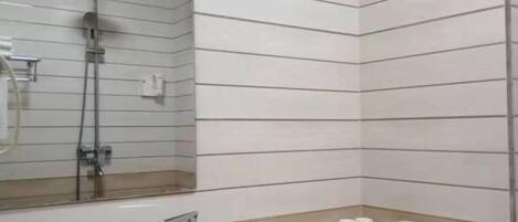 A bathroom with a sink, mirror, and toiletries.