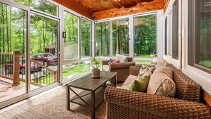A covered porch with wicker furniture, a wooden table, and a ceiling fan. - Private Hilltop Retreat | Hot Tub & 15 Min to Nashville3BR, 3.5 BA (Nashville)