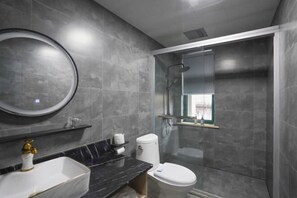A modern bathroom with a marble sink, toilet, and a glass-enclosed shower. - Shaoxing Shun'an Collection Hotel (Lu Xun's Hometown Yintai Branch) (Shaoxing)
