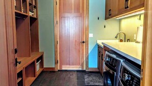 A compact kitchen with wooden cabinets, a built-in oven, and a sink. - Stunning mountain views, quiet, peaceful, unique, private attached guest suite (Bend)
