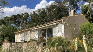 A house with a tiled roof, white shutters, and a stone wall in front. - VILLA HORTUS MARIAE - LE THORONET (LE THORONET)