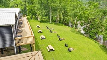 A deck with outdoor seating and a view of a river.