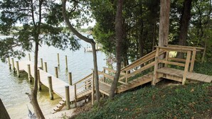 A wooden dock extending into a lake, surrounded by trees and a grassy area. - 4BDRM River front house with Private Beach in Hollywood (Hollywood)