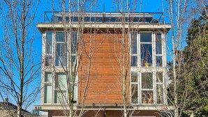 A modern multi-story building with large windows and a wooden facade. - Walk to Space Needle from a Cap Hill Loft w/VIEWS (Seattle)
