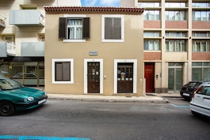 A two-story building with a sign indicating 'Holiday Home.'