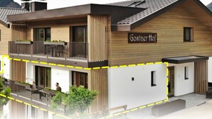 Un bâtiment moderne à deux étages, doté d’une façade en bois, de balcons et d’une enseigne indiquant « Gosner Hof ».