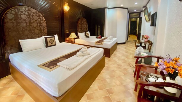 A hotel room with two beds, a desk, and a chair. - Impressive Boutique Hotel (Hanoi)