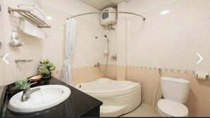 A bathroom with a sink, toilet, and a shower area. - Impressive Boutique Hotel (Hanoi)