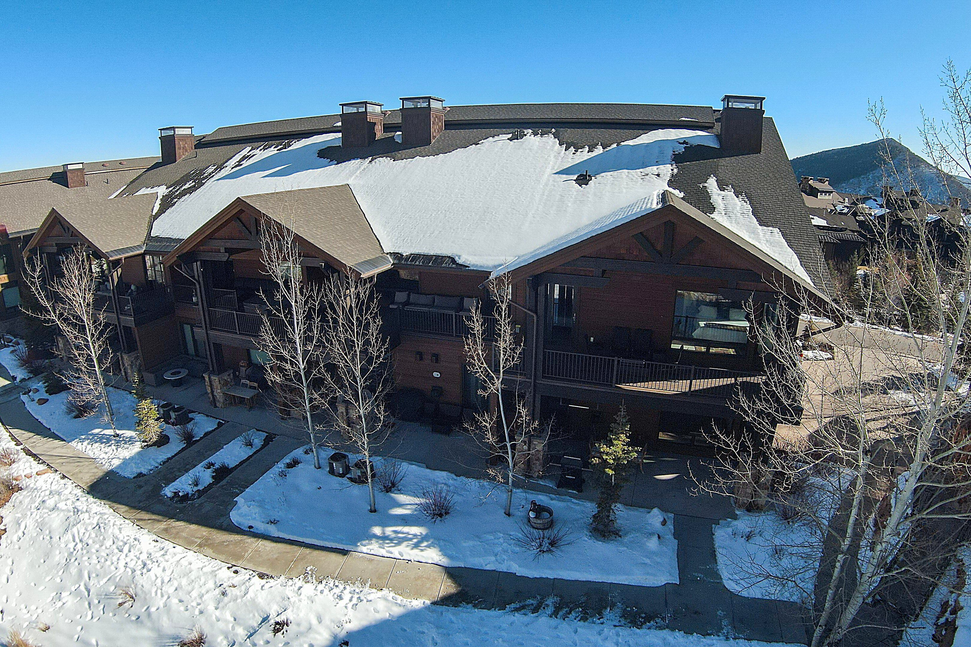 A large building with multiple balconies and a snow-covered roof.