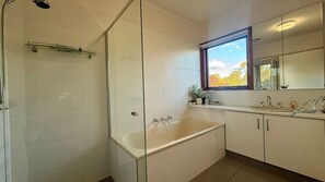 A modern bathroom with a glass shower enclosure, a freestanding bathtub, and a large window providing natural light. - Relaxing Family Farmstay Shepparton 7mins to CBD (Kialla)