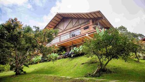 A traditional wooden building with a sloped roof and a balcony.