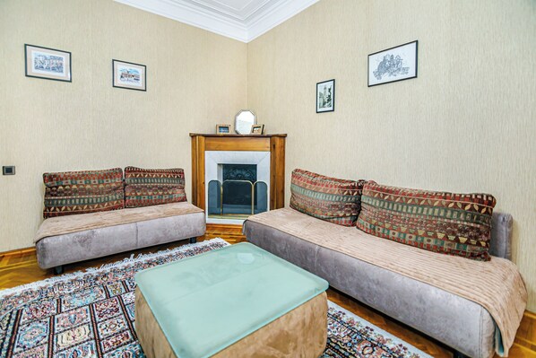 A living room with two sofas, a coffee table, and a fireplace.
