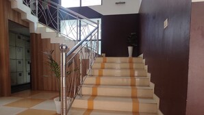 A staircase with a metal railing leading to an upper floor.