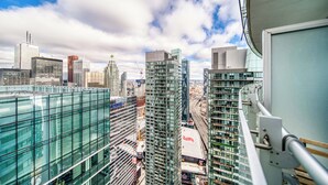 A high-rise building with a glass facade and a view of the city skyline. - Gsuite Express Downtown Toronto (Toronto)