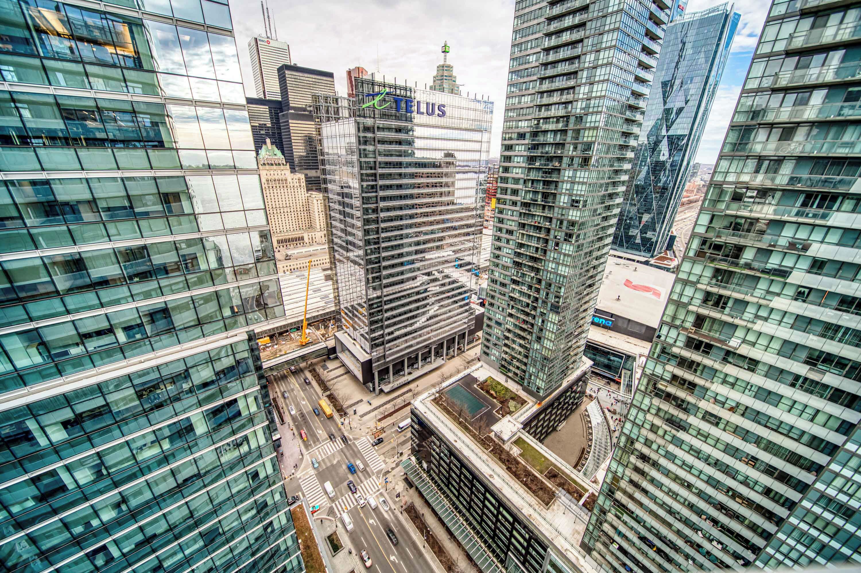 A high-rise urban area with modern glass buildings, including a prominent 'FELIX' sign.