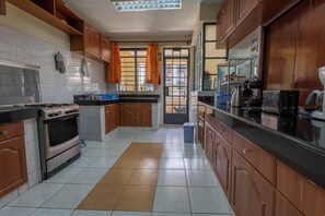 Superior Apartment, 3 Bedrooms, Kitchen, Ground Floor | Private kitchen | Electric kettle, highchair, dining tables - Takdiri Home Superior (Nairobi)