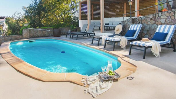 A swimming pool with lounge chairs and a stone wall. - Large house, pool, AC, parking - 13 guests (Vall-llòbrega)