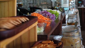 A buffet setup with various food items and a coffee station. - Uppuveli Beach by DSK (Trincomalee)