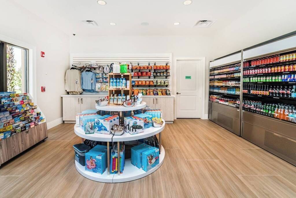 A retail store with a central display of toys and a refrigerated section on the right.